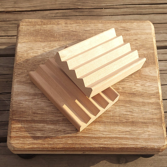 Wooden cutting board with soap bars on a wooden surface