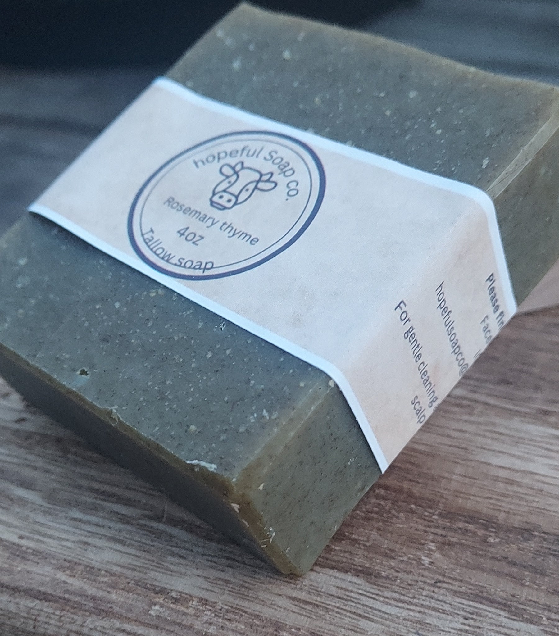 Bar of soap with a label on a wooden surface