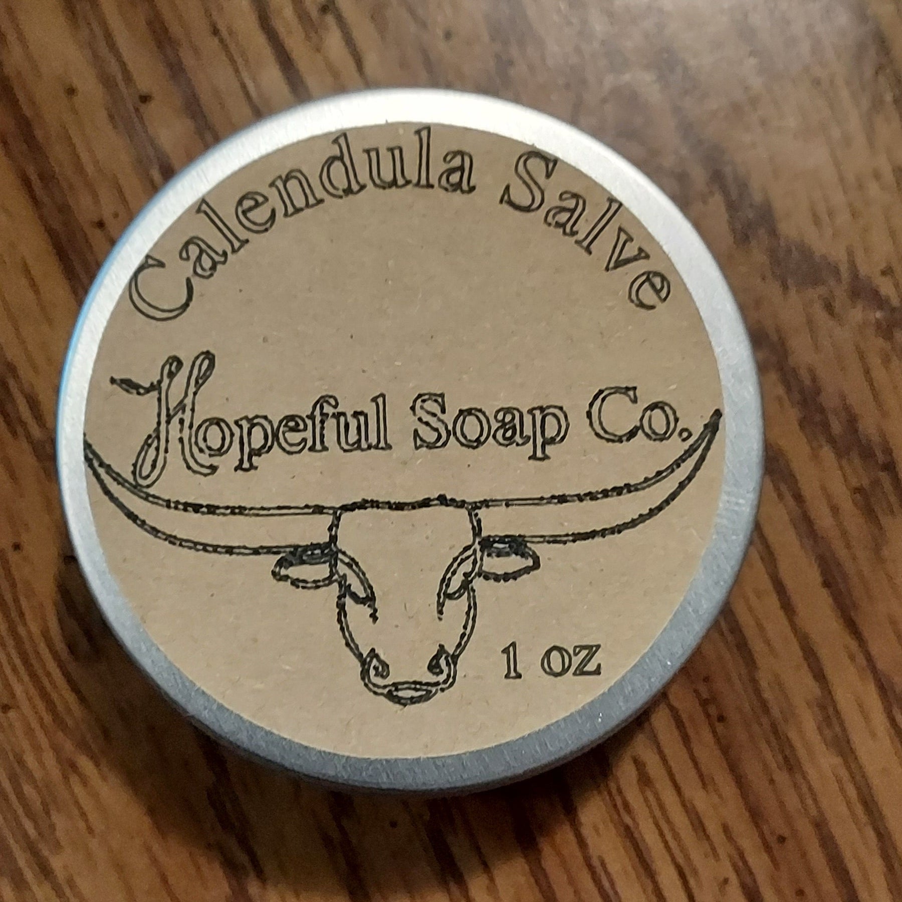 Small cylindrical container with a label on a wooden surface